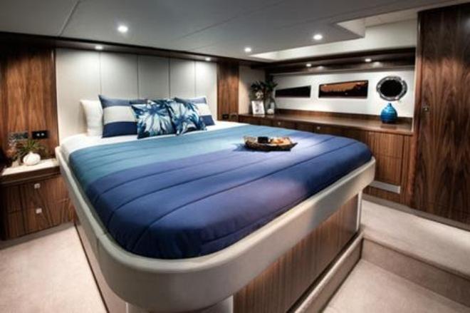 The 5400 Sport Yacht's full-beam master stateroom has a king-sized walk-around bed as well as long, fixed hull windows and opening portholes. © Riviera Australia
